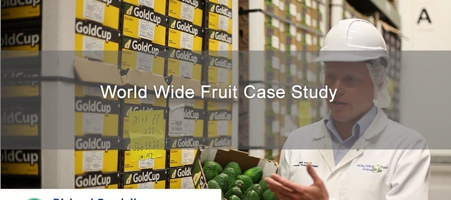 image of employee holding box of avocados